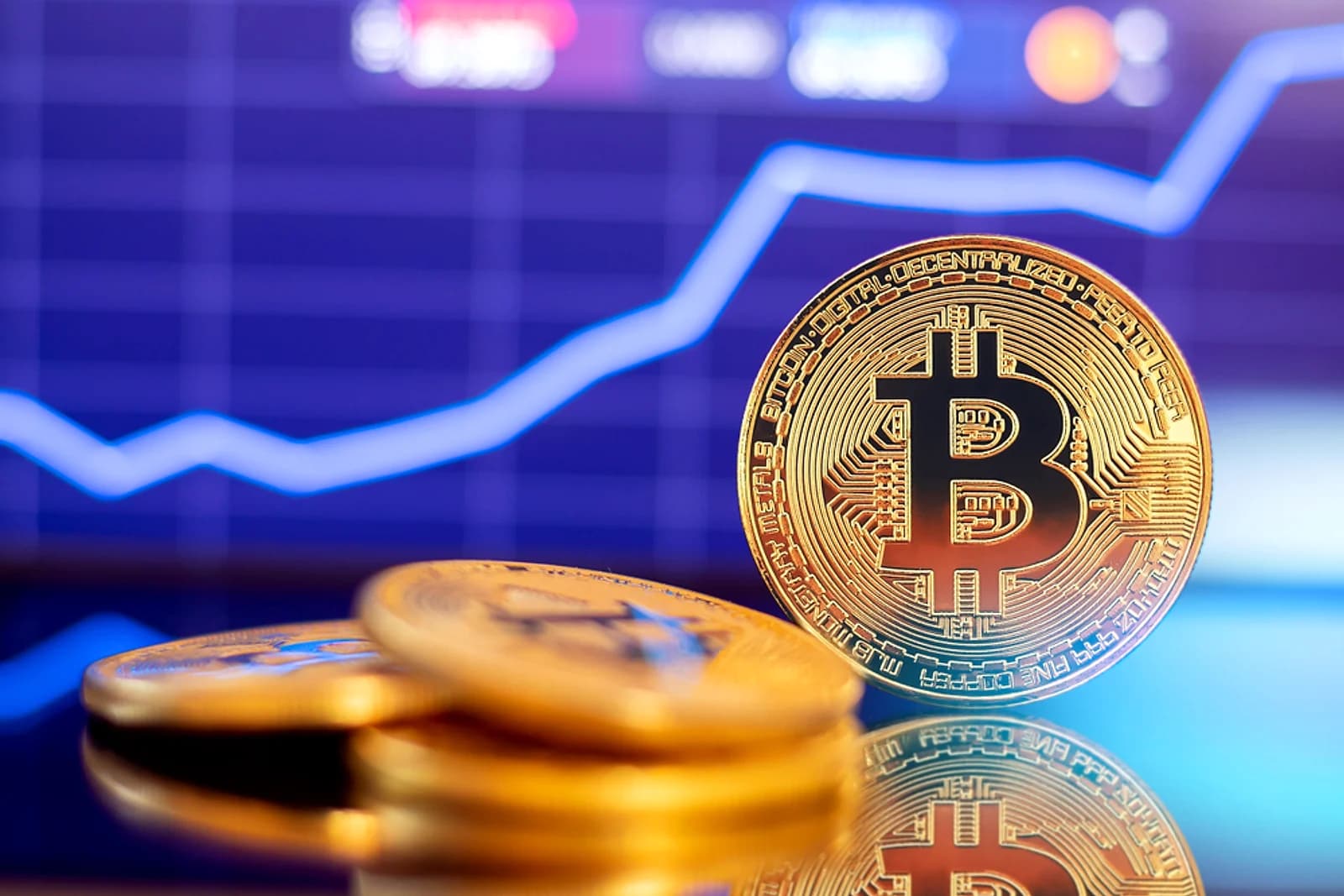 Bitcoin coins in front of a rising blue market chart for an AntiMedia news article about BTC crossing 85000 dollars