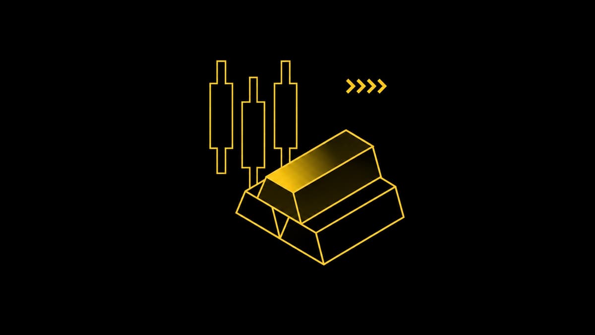 Gold bars and candlestick chart symbols on a black background