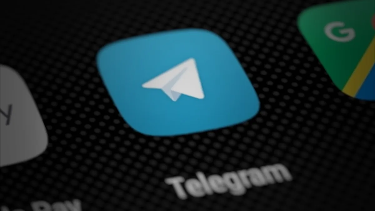 The Telegram app icon on a smartphone home screen, shot close up